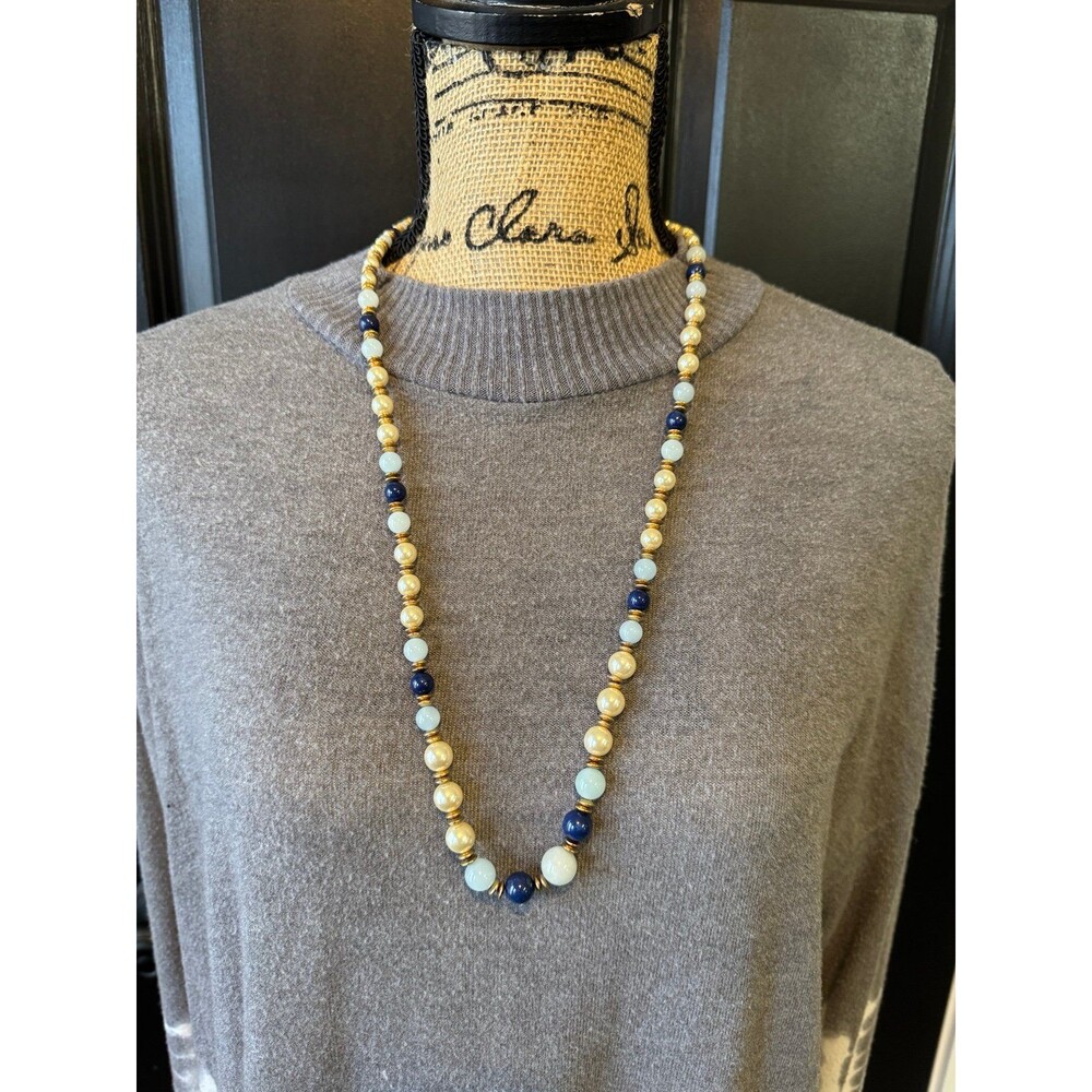 Blue and gold beaded necklace featuring navy and light blue beads with gold-